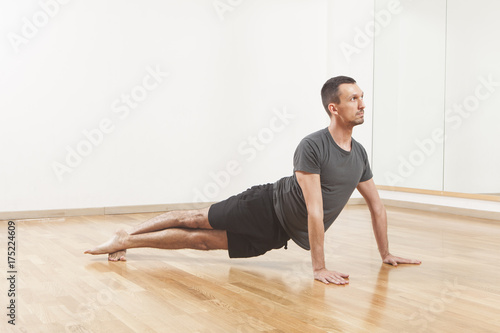 Pilates instructor performing fitness exercise at the gym indoor