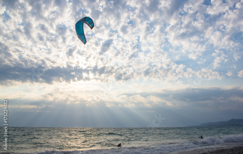 kitesurfer rides a kite-surf on waves of the sea