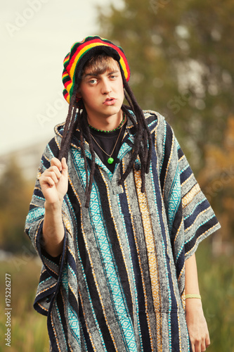 Sad young fashion hippie man walking outdoor