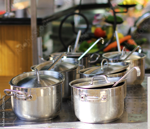 Six saucepans of stainless steel on the stove