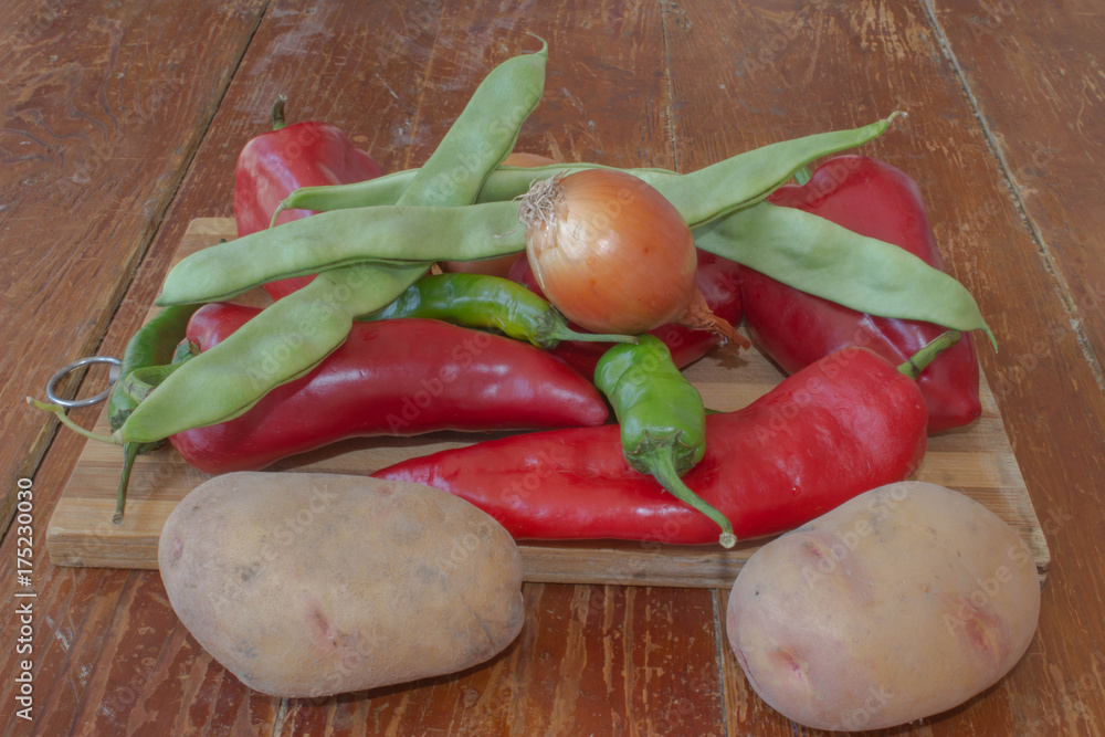 fresh organic vegetables, potato, onion, green french beans and pepper on wooden floor fresh organic vegetables, potato, onion, green french beans and pepper on wooden floor