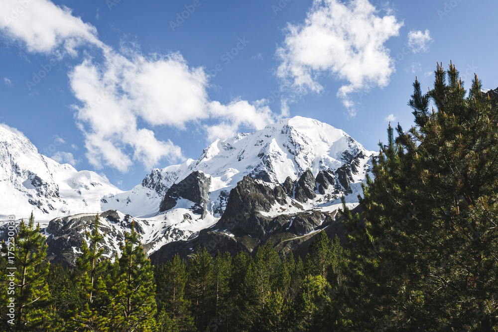 Snow mountain peaks of Caucasus mountains in cold cloudy weather, Elbrus Region. Top of Ullu-Tau mountain