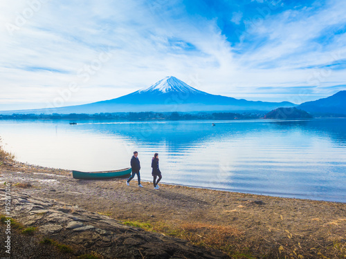 silhouette asia couple traveler 30s to 40s walking at side of lake kawaguchi on morning time with fuji mountain background