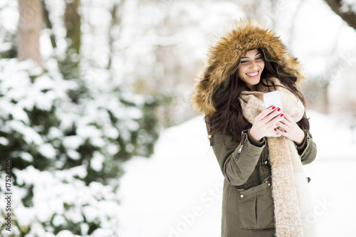 Smiling woman using phone i...