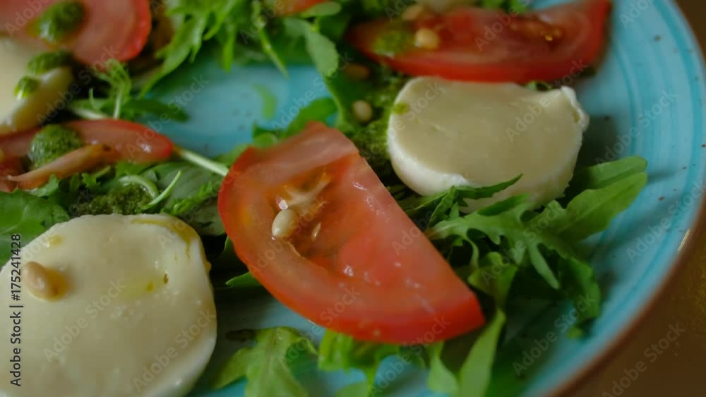 close-up - female eating salad sitting in cafe in city, female watering sauce delicious Italian salad at the restaurant close-up - female eating salad sitting in cafe in city, female watering sauce delicious Italian salad at the restaurant