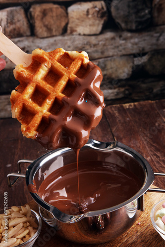 Belgium waffles with chocolate sauce. popsicles with chocolate and wafer.