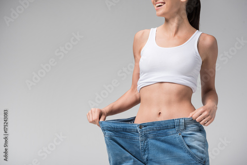 Joyful slim girl showing result of diet