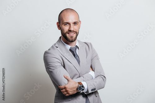 Portrait of a successful businessman in a suit, business coach / consulting. Studio shot with a flipchart on a white background.
