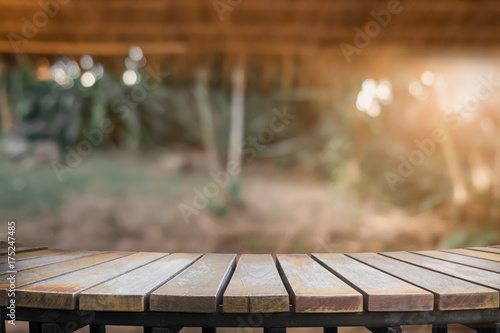Product display montage of Empty wooden table and blurred forest walkway view or natural background