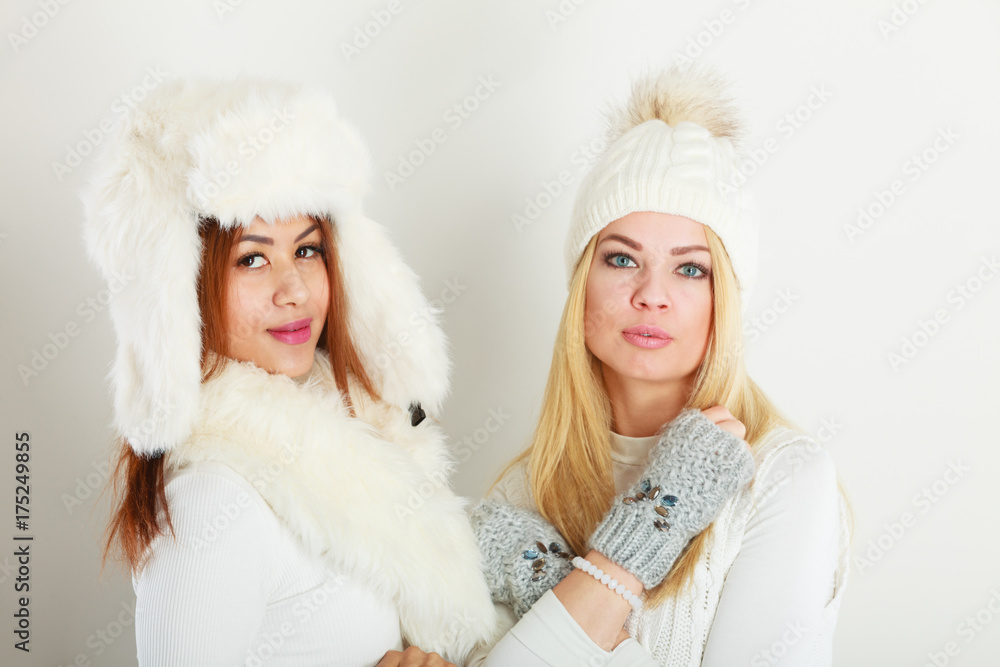 Two ladies in winter white outfit. Two ladies in winter white outfit.
