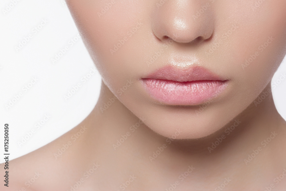 The macro photo of the closed female mouth with a natural shade of lips. Demonstration of care of skin of lips. Cosmetology, Spa, cosmetics, injections The macro photo of the closed female mouth with a natural shade of lips. Demonstration of care of skin of lips. Cosmetology, Spa, cosmetics, injections