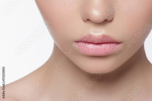 The macro photo of the closed female mouth with a natural shade of lips. Demonstration of care of skin of lips. Cosmetology  Spa  cosmetics  injections