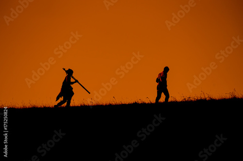 Silhouettes of traveler with backpacks hiking top of mountain on sunset at Doi Mon Jong Chiang Mai Thailand.