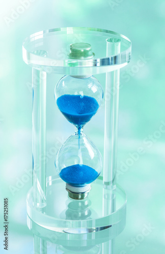Time passing. Blue hourglass.