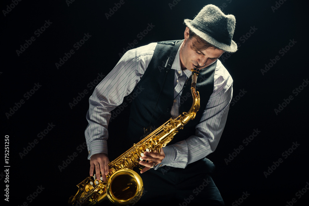 Naklejka premium Young man playing the Saxophone