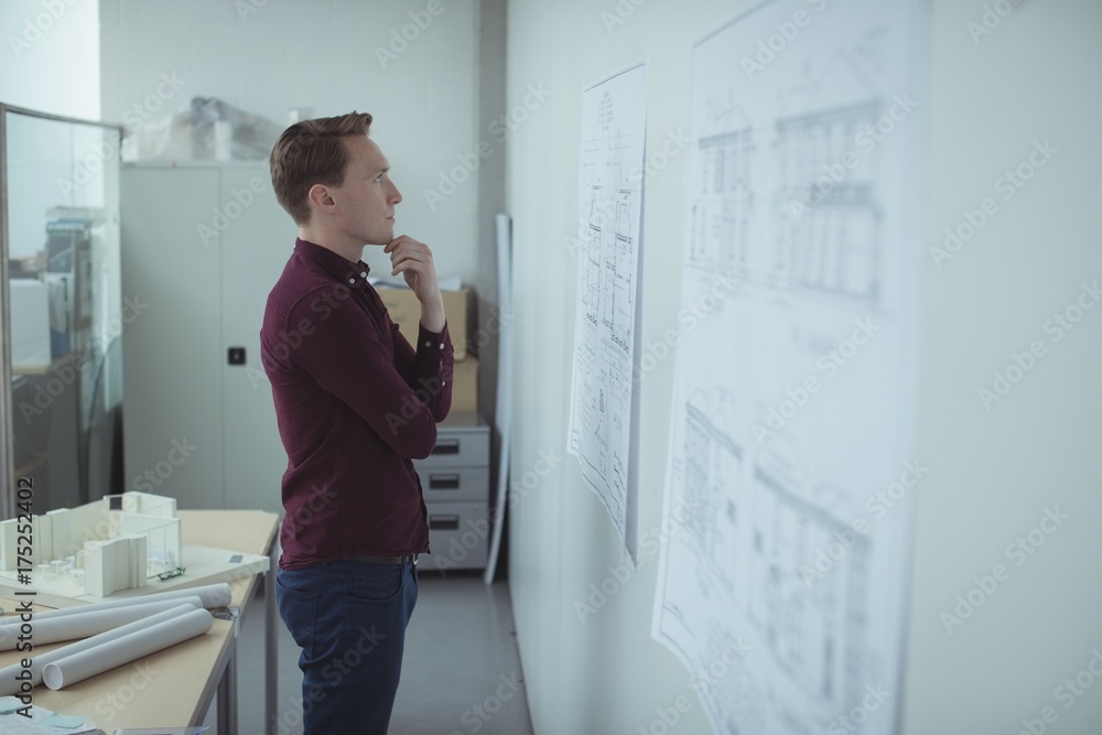 Architect looking at blueprint Architect looking at blueprint
