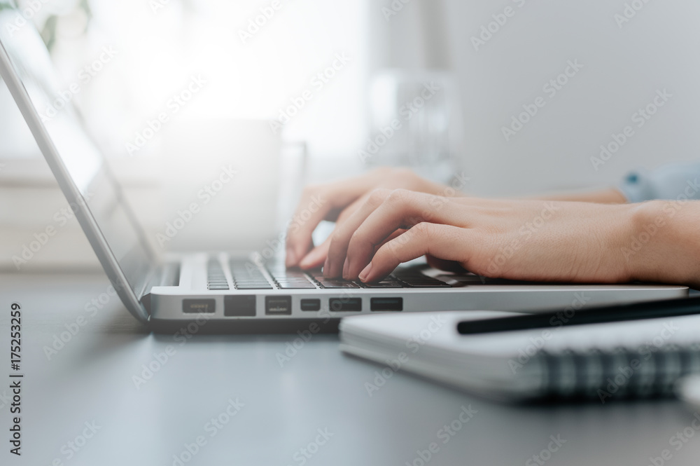 Woman working at home office hand on keyboard close up Woman working at home office hand on keyboard close up