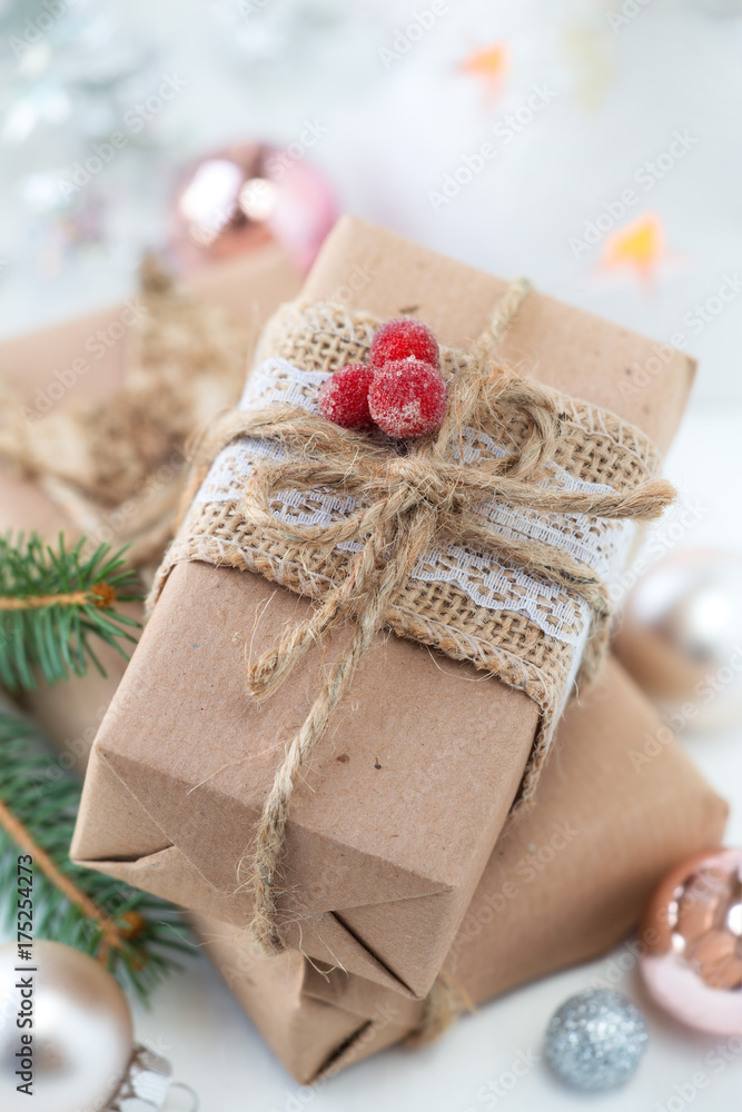 Stack of craft paper wrapped Christmas gifts with festive decorations Stack of craft paper wrapped Christmas gifts with festive decorations