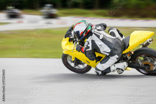 Motorcycle practice leaning into a fast corner on track