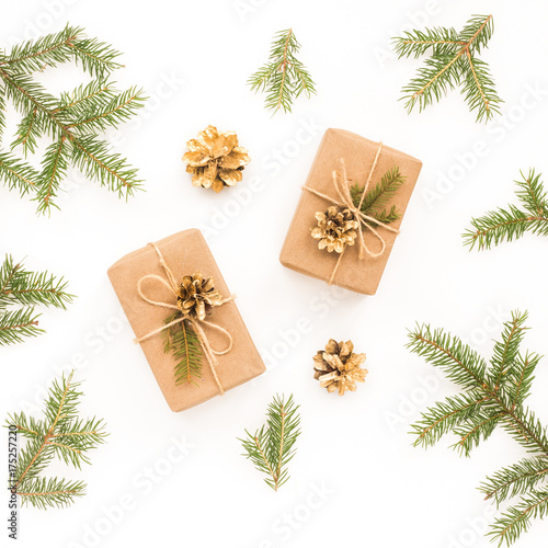 Christmas gift, spruce branches, golden christmas decorattion, golden pine cone on white background. Top view, flat lay, square