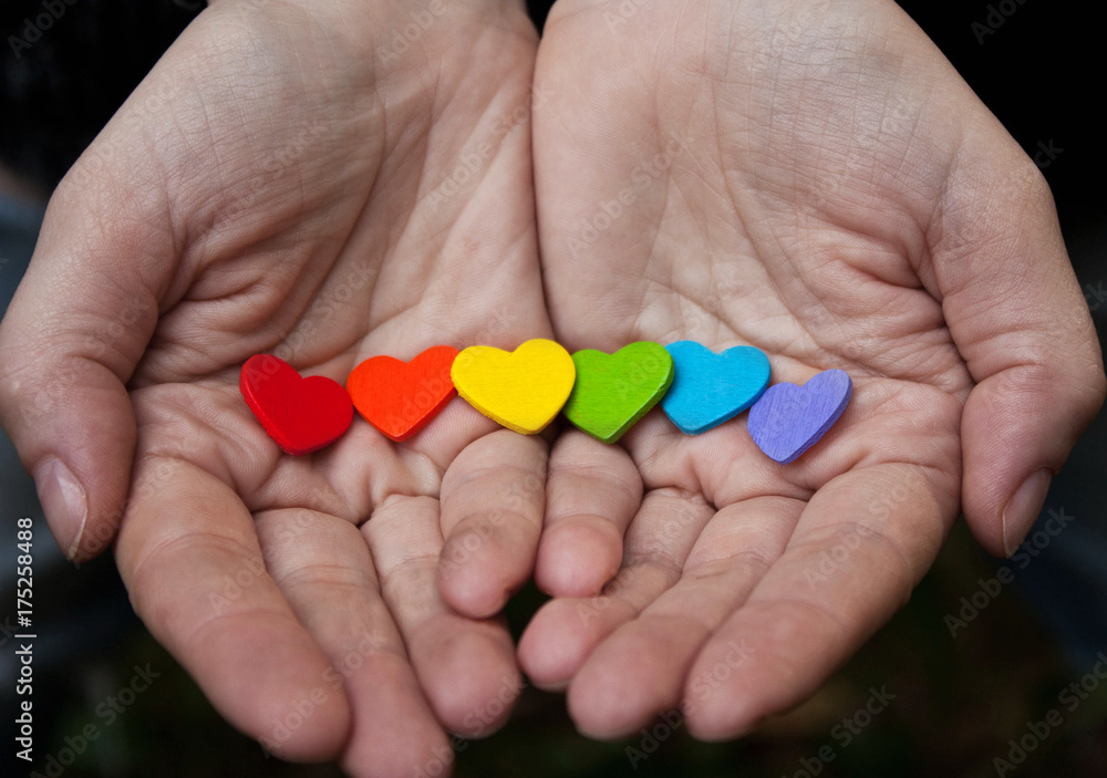 Background of LGBT .hearts of the color of the rainbow in  hand