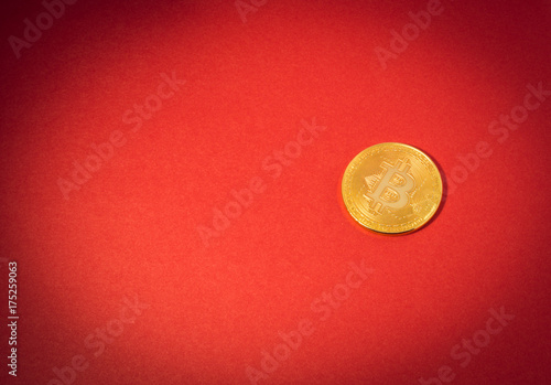 Cryptocurrency physical golden bitcoin coin. Bitcoin, golden bitcoin, yellow bitcoin in red paper background