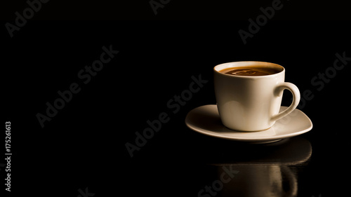 Coffee in the white cup on the black background