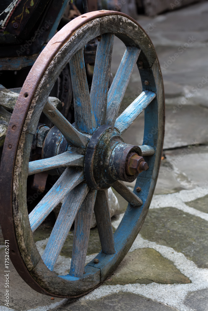 An old antique wagon wheel made of wood and metal