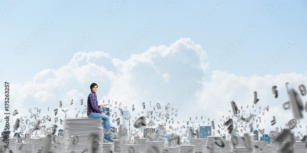 Attractive man sitting on pile of paper documents. Attractive man sitting on pile of paper documents.