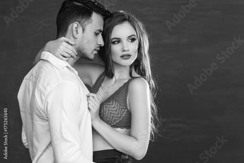 Fashion portrait of a beautiful sexy couple. Black and white image