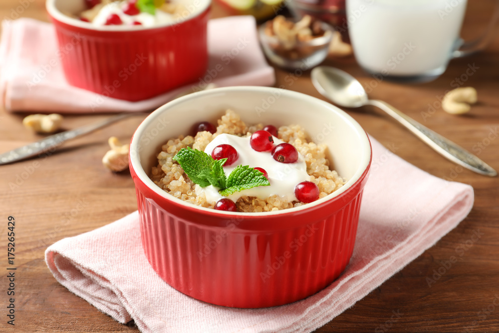 Ramekin with tasty quinoa on wooden table Ramekin with tasty quinoa on wooden table