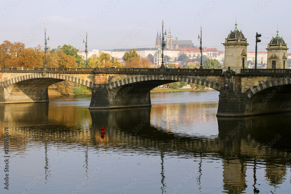 Fototapeta premium View of the Prague Castle and the bridge on the Vltava River in a misty autumn morning. Prague. Czech Republic .
