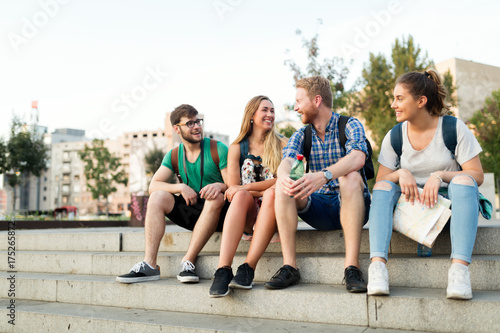 Fotografi Young students being happy at campus stairs