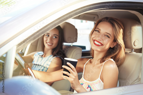 Beautiful young women in car