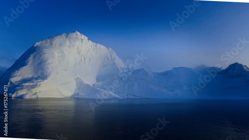 Arctic Icebergs Greenland in the arctic sea. You can easily see that iceberg is over the water surface, and below the water surface. 