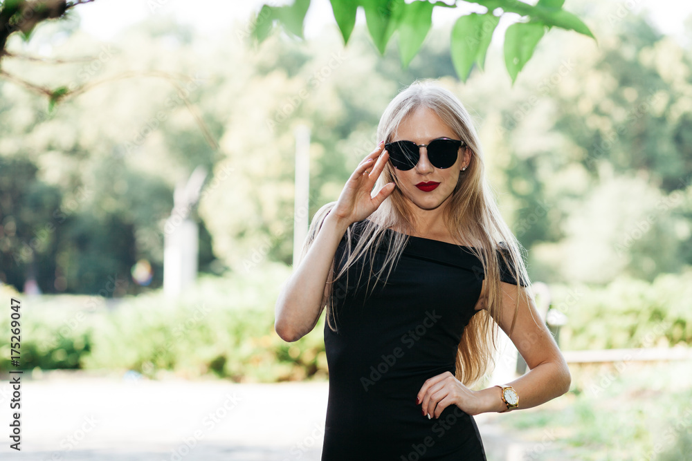 Portrait of beautiful woman in black dress, sunglasses and red lipstick Portrait of beautiful woman in black dress, sunglasses and red lipstick