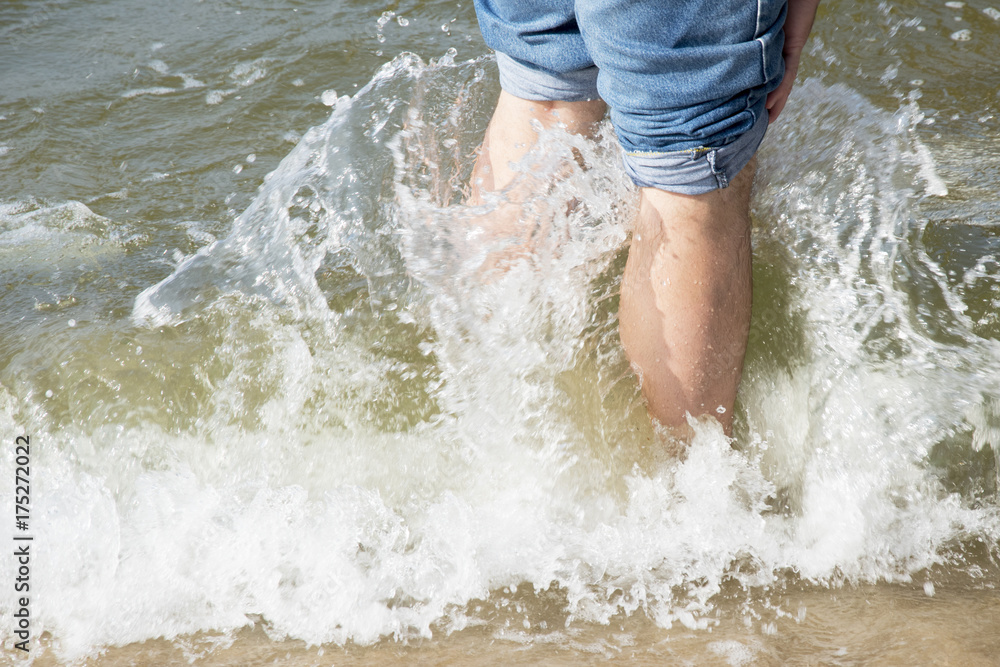 legs in wave sea photo. Beautiful picture, background, wallpaper legs in wave sea photo. Beautiful picture, background, wallpaper