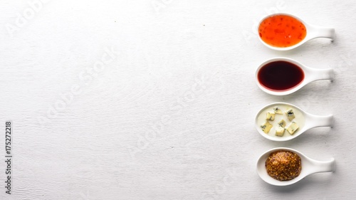 A set of sauces and spices. On a wooden background. Top view. Free space for text.