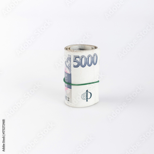Detail of czech money, the roll of czech money on white background - the czech currency