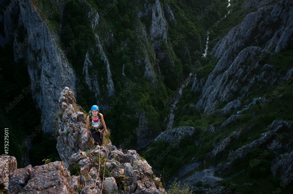 Young woman walking on a steep ridge Young woman walking on a steep ridge
