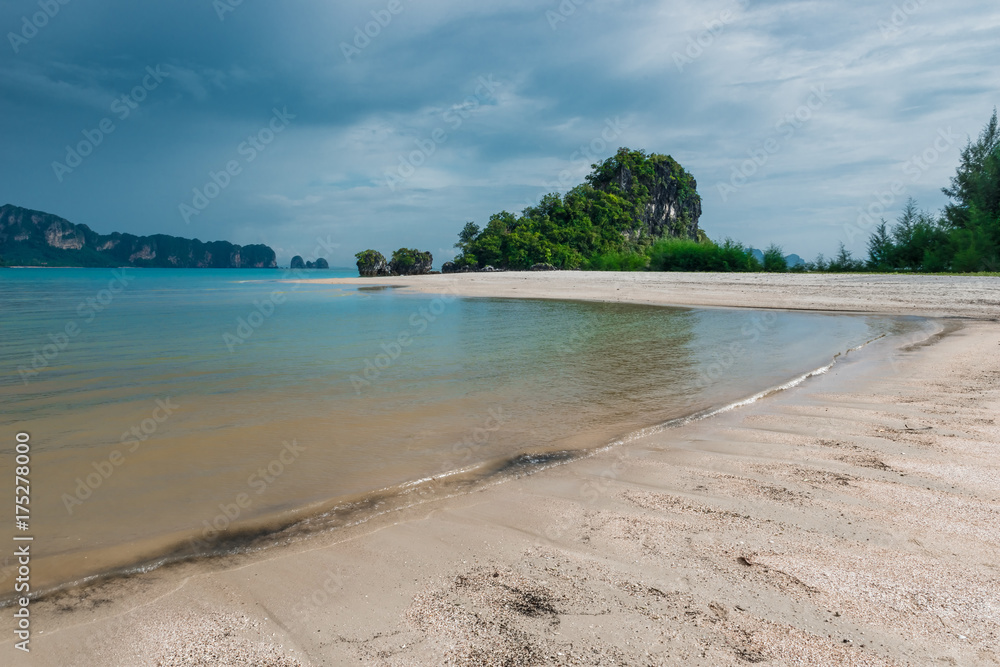 heavy gray clouds surging above the calm Andaman Sea in Thailand