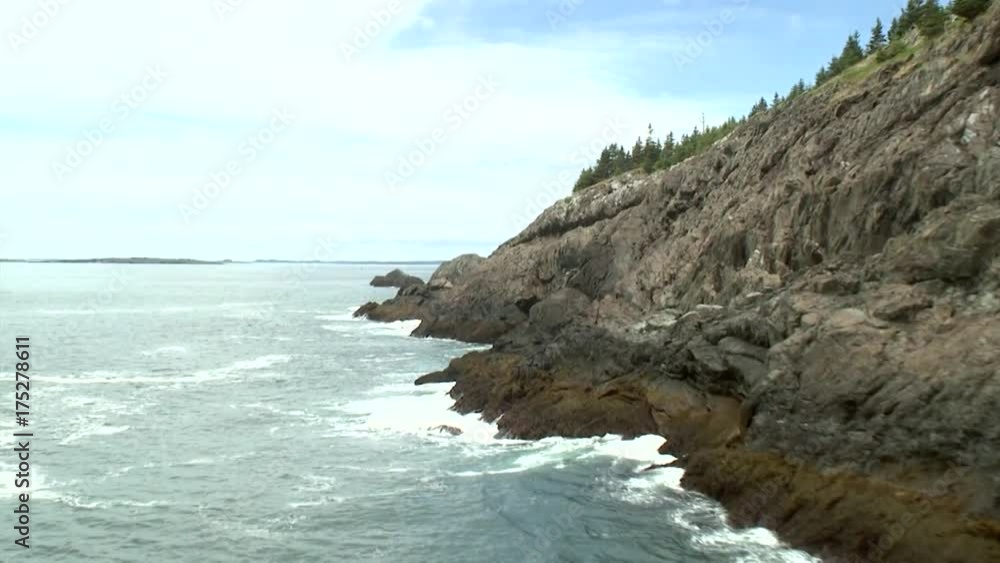 Waves crash on rocky cliffs in Acadia National Park, aerial Waves crash on rocky cliffs in Acadia National Park, aerial