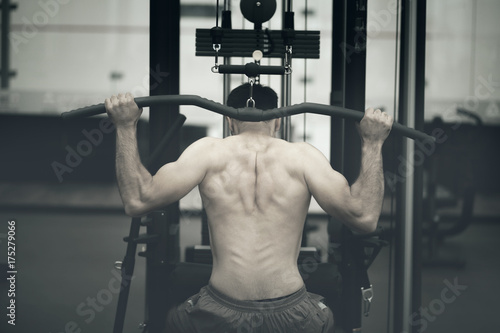 young male bodybuilder doing heavy weight exercise