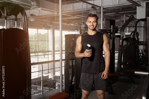 Sporty young man with bottl...