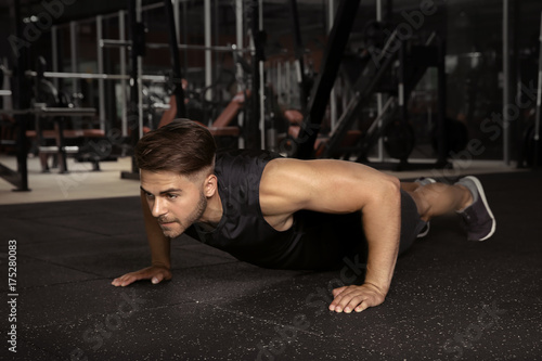 Young sporty man doing push...