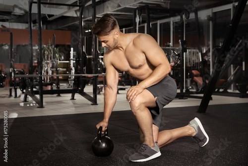 Young sporty man doing exer...