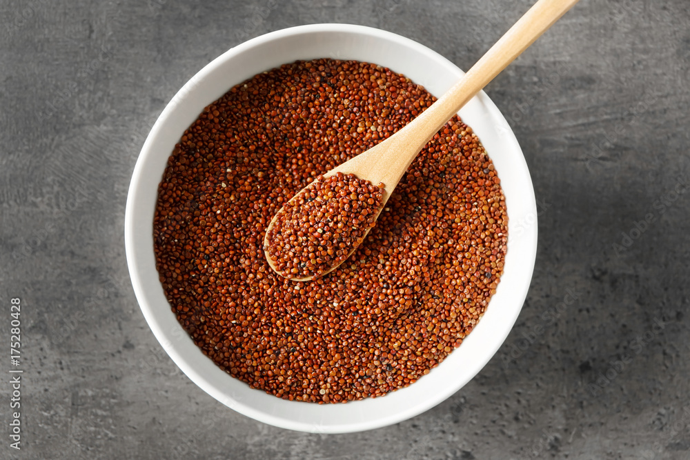 Spoon with quinoa seeds in bowl on table Spoon with quinoa seeds in bowl on table