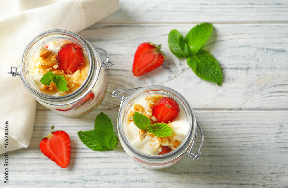 Jars with strawberry pretzel salad on table Jars with strawberry pretzel salad on table