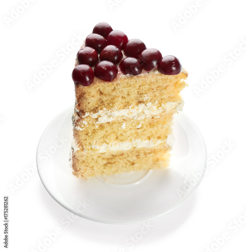 Piece of cake decorated with cherries on white background