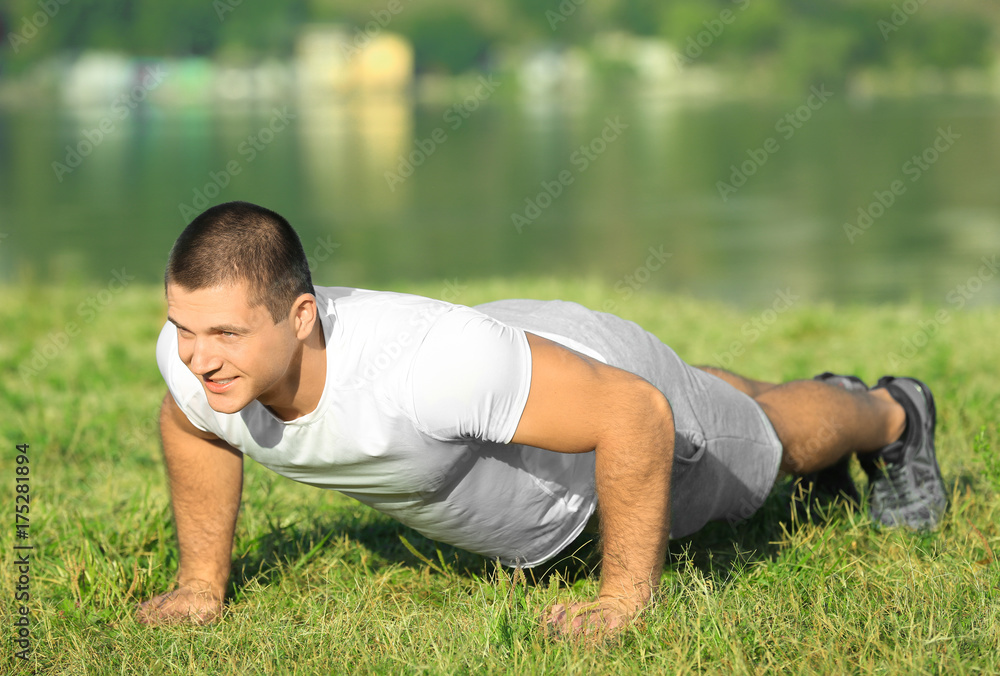 Handsome young man training outdoors